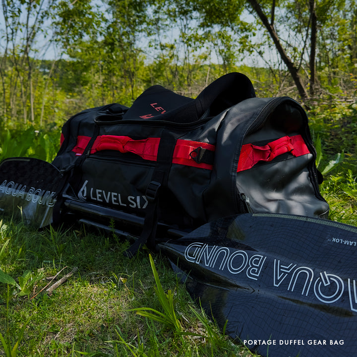 Portage duffel gear bag with red accents on grass